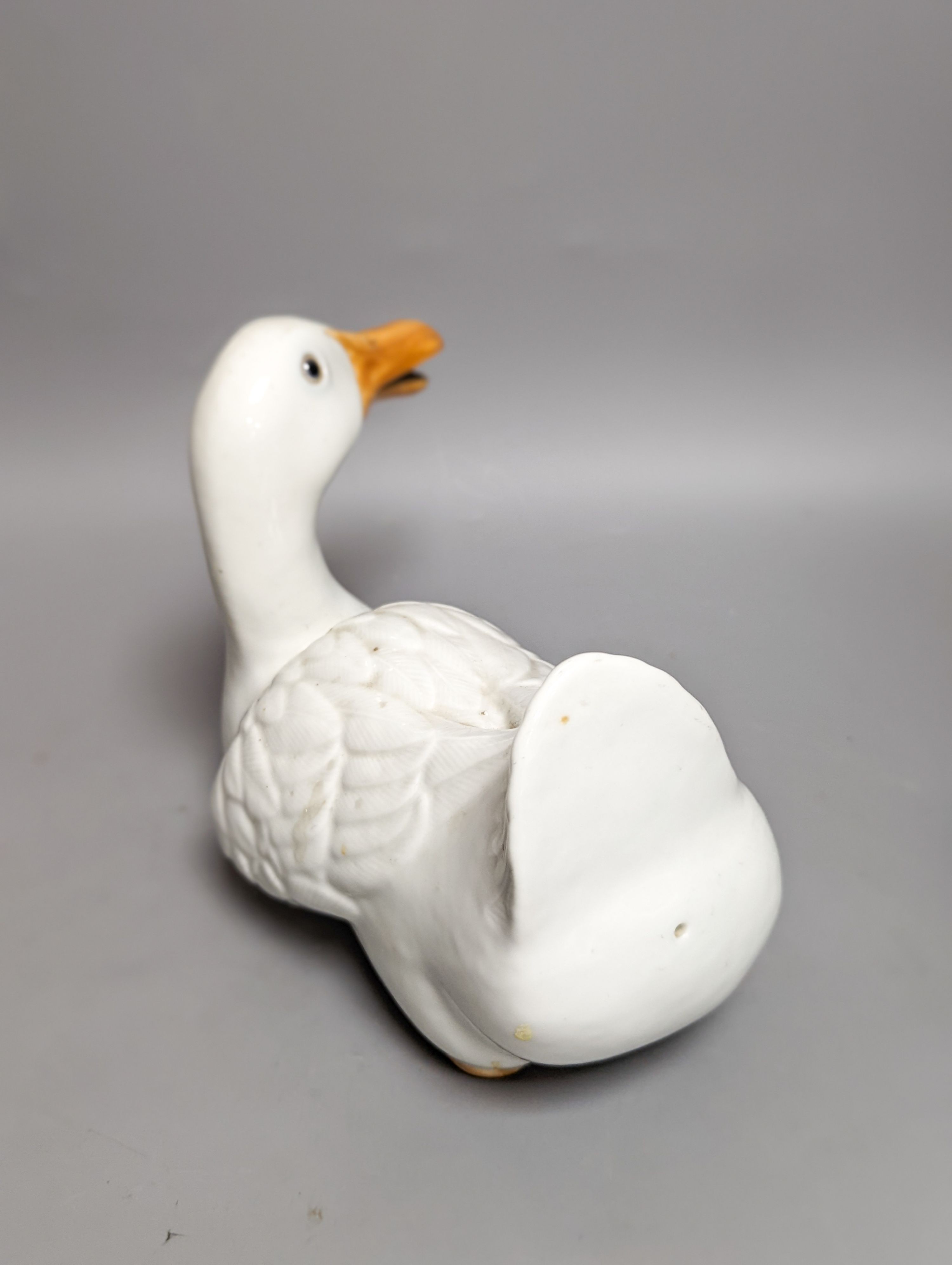 A modern painted decoy duck and a 20th century Chinese ceramic model duck (2) 42cm